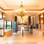 Elegant black marble entrance to Dr. Songabau's OB/GYN practice located within Louis Pasteur Private Hospital, Pretoria, featuring a mirror with the clinic's name, white orchids, and a brass lamp.